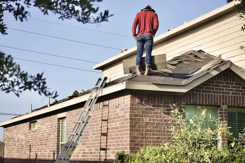 Professional roofer working on a residential roof in Piney Oaks